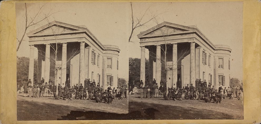 Freedpeople and teachers assembled in front of the columned Beaufort library building in South Carolina.